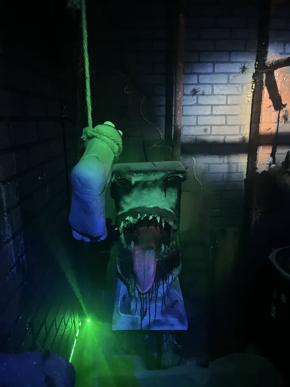 Monster toilet prop with fangs under green light